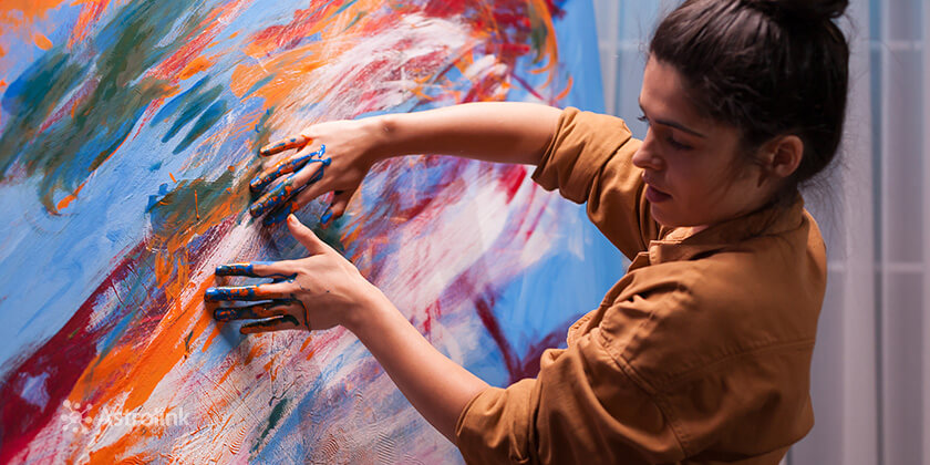 Woman painting with her hands